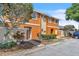 Attractive townhouse featuring vibrant exterior, manicured landscaping, and close resident parking at 46 Silver Falls Cir, Kissimmee, FL 34743
