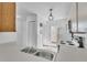 Well-lit kitchen featuring stainless steel appliances, white cabinetry, and a view to the outside at 46 Silver Falls Cir, Kissimmee, FL 34743