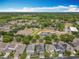 Aerial view of homes surrounding a pond with mature trees and landscaping in a well-planned community at 473 Oviedo Blvd, Oviedo, FL 32765