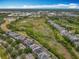Community aerial showcasing lush greenery surrounding modern homes, with ample space between each at 473 Oviedo Blvd, Oviedo, FL 32765