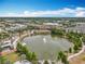 Aerial view of community featuring large lake with fountain and walking paths at 473 Oviedo Blvd, Oviedo, FL 32765