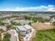 Aerial view of community with a lake, park, surrounding residences, trees and green space at 473 Oviedo Blvd, Oviedo, FL 32765