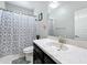 Bathroom featuring a vanity with a marble countertop, a toilet, and a shower with stylish curtains at 473 Oviedo Blvd, Oviedo, FL 32765