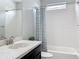 Updated bathroom featuring a sleek vanity with marble countertops, tub, and modern fixtures at 473 Oviedo Blvd, Oviedo, FL 32765