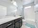Updated bathroom features a sleek vanity with quartz countertops, tub, and modern fixtures at 473 Oviedo Blvd, Oviedo, FL 32765