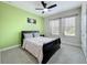 Bright bedroom featuring a ceiling fan, complemented by natural light streaming through the windows at 473 Oviedo Blvd, Oviedo, FL 32765