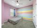 Bright bedroom with a colorful accent wall, ceiling fan, and a large window at 473 Oviedo Blvd, Oviedo, FL 32765
