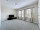 Neutral bonus room featuring plush carpeting, lots of natural light, and a modern entertainment center at 473 Oviedo Blvd, Oviedo, FL 32765
