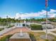 Community park with lake, water features, seating, lush greenery, and the American flag at 473 Oviedo Blvd, Oviedo, FL 32765