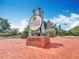 Community sign for Oviedo on the Park with brick base and decorative metal accents against a blue sky at 473 Oviedo Blvd, Oviedo, FL 32765