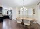 Chic dining room with wood table, velvet chairs, and modern lighting next to the kitchen at 473 Oviedo Blvd, Oviedo, FL 32765