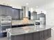 Granite countertops and stainless appliances in the kitchen provide a sleek look at 473 Oviedo Blvd, Oviedo, FL 32765
