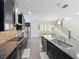 Bright kitchen boasts granite counters, stainless appliances, dark cabinets, and a center island at 473 Oviedo Blvd, Oviedo, FL 32765