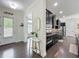 A kitchen featuring dark cabinetry, stainless appliances, hardwood floors and view into adjacent living space at 473 Oviedo Blvd, Oviedo, FL 32765