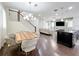 Open-concept living and dining areas with staircase and modern furnishings at 473 Oviedo Blvd, Oviedo, FL 32765