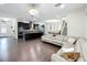 Spacious open-concept living area featuring hardwood floors, a kitchen, and comfortable seating at 473 Oviedo Blvd, Oviedo, FL 32765