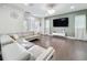 Bright living room with a modern sectional sofa, decorative wall accents, and natural light at 473 Oviedo Blvd, Oviedo, FL 32765