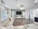 Spacious living room featuring a modern sectional sofa and a large wall-mounted TV at 473 Oviedo Blvd, Oviedo, FL 32765