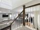 Open-concept living space with hardwood floors, stylish staircase, and modern kitchen with dark cabinets at 473 Oviedo Blvd, Oviedo, FL 32765