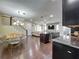 Open-concept living space featuring hardwood floors, a modern kitchen, and a staircase in the background at 473 Oviedo Blvd, Oviedo, FL 32765