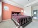 Spacious main bedroom with a large window, tray ceiling and an ensuite bathroom entrance at 473 Oviedo Blvd, Oviedo, FL 32765