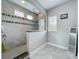 Large shower featuring designer tile work, a frameless enclosure, and natural light at 473 Oviedo Blvd, Oviedo, FL 32765