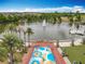 Overhead view of splash pad, lake, fountain, swan boats, and residences providing a recreational community setting at 473 Oviedo Blvd, Oviedo, FL 32765