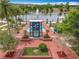 Overhead view of town center with lake, community info displays, splash pad, and garden spaces for community engagement at 473 Oviedo Blvd, Oviedo, FL 32765