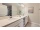 Elegant bathroom with double sinks, white cabinets, quartz countertops, and modern fixtures at 4731 Clock Tower Dr # 105, Kissimmee, FL 34746