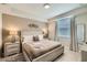 Inviting bedroom with a queen-sized bed, neutral tones, and ample natural light at 4731 Clock Tower Dr # 105, Kissimmee, FL 34746