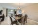 Dining room with a view to the outside featuring modern furnishings and decor, seamlessly flowing into the living spaces at 4731 Clock Tower Dr # 105, Kissimmee, FL 34746
