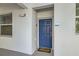 Close-up of unit 105's blue front door, featuring a 
