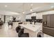 Modern kitchen featuring white cabinets, stainless steel appliances, and an island with bar seating at 4731 Clock Tower Dr # 105, Kissimmee, FL 34746