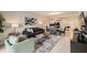 Open-concept living area with contemporary furnishings and decor, seamlessly flowing into the dining and kitchen spaces at 4731 Clock Tower Dr # 105, Kissimmee, FL 34746