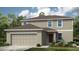 Charming two-story home with a two car garage and professionally landscaped front yard at 4740 Cloister St, Kissimmee, FL 34758