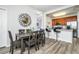 Dining area featuring wood-look floors and modern lighting adjacent to kitchen with breakfast bar at 4802 Cayview Ave # 301, Orlando, FL 32819