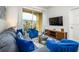 Cozy living room with comfortable seating, a TV, and access to a balcony at 4802 Cayview Ave # 301, Orlando, FL 32819