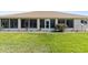 Charming backyard featuring lush green grass and enclosed sunroom, perfect for enjoying outdoor living at 5076 Nw 21St Loop, Ocala, FL 34482