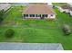 Spacious backyard with a well-kept lawn and screened-in porch offering plenty of space for outdoor living at 5076 Nw 21St Loop, Ocala, FL 34482