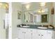 Well-lit bathroom includes a double sink vanity, stylish mirror, and ample counter space for storage at 5076 Nw 21St Loop, Ocala, FL 34482