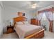 Comfortable bedroom featuring a ceiling fan, floral curtains, and natural light at 5076 Nw 21St Loop, Ocala, FL 34482