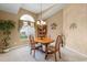 Bright dining room features a chandelier, a large window, and elegant decor accents for a cozy ambiance at 5076 Nw 21St Loop, Ocala, FL 34482