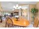 Open-concept dining area with chandelier, seamless flow into the living room, and views of adjacent spaces at 5076 Nw 21St Loop, Ocala, FL 34482