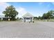 Community entrance features a welcoming gate house, fountain, and meticulously maintained landscaping at 5076 Nw 21St Loop, Ocala, FL 34482