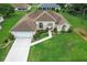 Well-maintained home featuring manicured lawn, welcoming front entrance, and attached two-car garage at 5076 Nw 21St Loop, Ocala, FL 34482