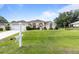 Inviting single-Gathering house with a manicured lawn and attached two-car garage in a residential area at 5076 Nw 21St Loop, Ocala, FL 34482