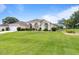 Spacious single-Gathering home with a well-kept lawn and mature landscaping on a sunny day at 5076 Nw 21St Loop, Ocala, FL 34482