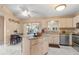 Functional kitchen with island, stainless steel appliances, and an adjacent dining area for casual meals at 5076 Nw 21St Loop, Ocala, FL 34482