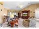 Comfortable living room featuring neutral colors, plush seating, a ceiling fan, and a large entertainment center at 5076 Nw 21St Loop, Ocala, FL 34482