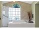 Serene bathroom features a soaking tub, separate glass shower, and a large window for natural light at 5076 Nw 21St Loop, Ocala, FL 34482